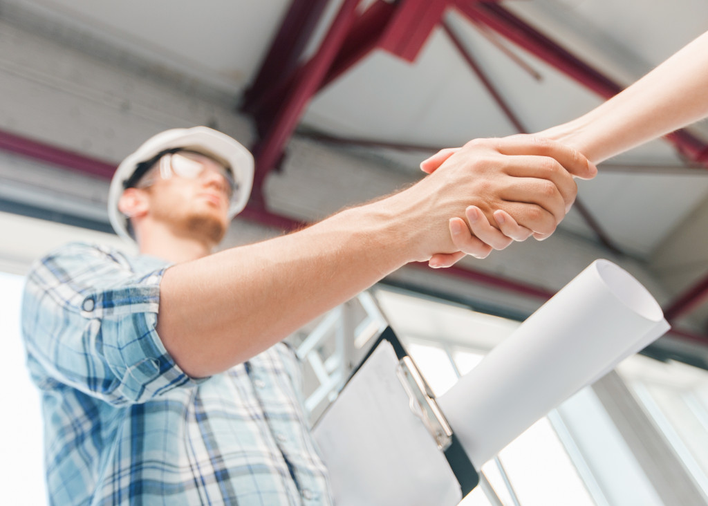 a contractor shaking hands of a client